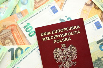Red polish passport and big amount of european euro money bills close up
