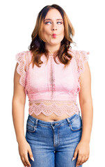 Fototapeta premium Young beautiful caucasian woman wearing casual clothes making fish face with lips, crazy and comical gesture. funny expression.
