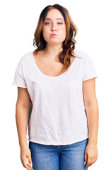 Obraz premium Young beautiful caucasian woman wearing casual white tshirt puffing cheeks with funny face. mouth inflated with air, crazy expression.