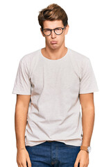 Fototapeta premium Handsome caucasian man wearing casual clothes and glasses depressed and worry for distress, crying angry and afraid. sad expression.