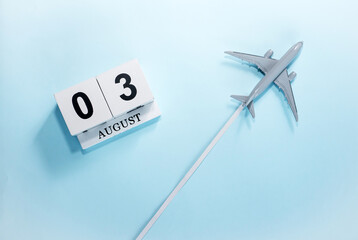 August calendar with number  3. Top view of a calendar with a flying passenger plane. Scheduler....