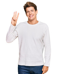 Fototapeta premium Handsome caucasian man wearing casual white sweater showing and pointing up with fingers number three while smiling confident and happy.