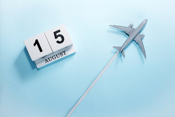 August calendar with number  15. Top view of a calendar with a flying passenger plane. Scheduler....