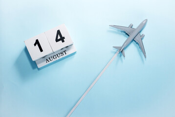 August calendar with number  14. Top view of a calendar with a flying passenger plane. Scheduler....