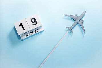 August calendar with number  19. Top view of a calendar with a flying passenger plane. Scheduler....
