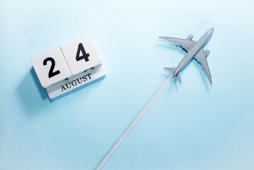August calendar with number  24. Top view of a calendar with a flying passenger plane. Scheduler....