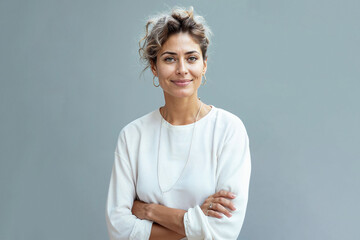 Confident Woman in Casual White Top with Arms Crossed
