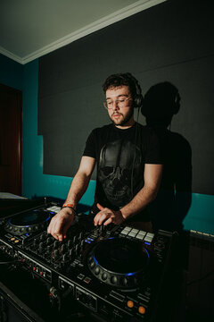 Concentrated DJ mixing tracks on professional equipment