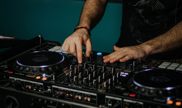 Close-up of DJ mixing music on professional equipment
