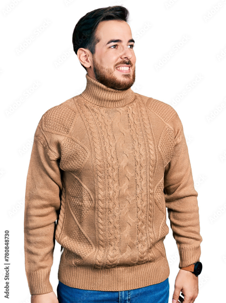 Wall mural Young hispanic man wearing casual clothes looking away to side with smile on face, natural expression. laughing confident.