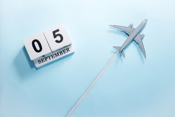 September calendar with number  5. Top view of a calendar with a flying passenger plane. Scheduler....