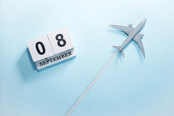 September calendar with number  8. Top view of a calendar with a flying passenger plane. Scheduler....