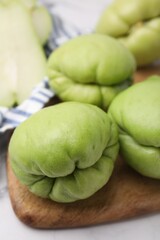 Fresh green chayote on light table, closeup