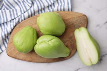 Fresh green chayote on light marble table, top view