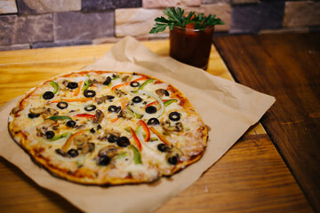 Delicious street pizza with some ingredients at side