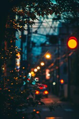 Vibrant night street scene with focus on the bokeh effect of city lights and red traffic signals amidst foliage