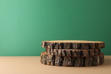 Presentation for product. Wooden stumps on color background. Space for text