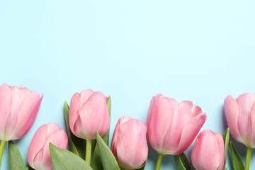 Naklejka premium Happy Mother's Day. Beautiful pink tulips on light blue background, flat lay. Space for text