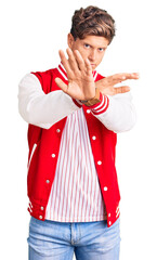 Young handsome man wearing baseball uniform rejection expression crossing arms doing negative sign,...