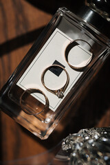 Three beautiful golden rings on elegant perfumes. In the middle ring with diamond 