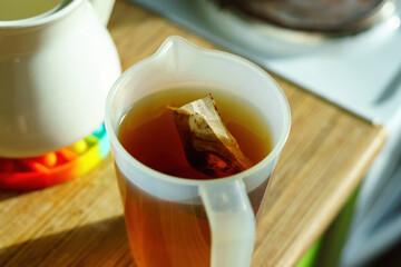 The tea bag is brewed in a plastic container