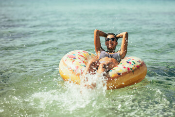 Woman Riding Inflatable Tube in Ocean