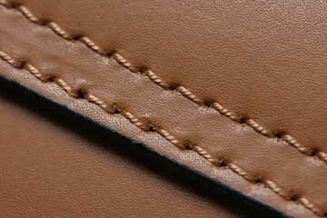 Brown natural leather with seam as background, top view