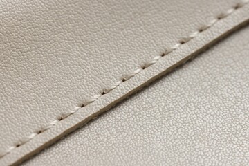 Beige leather with seam as background, closeup view