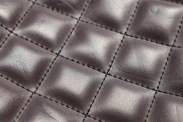 Brown natural leather with seams as background, closeup