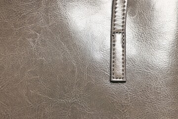 Natural leather with seams as background, top view