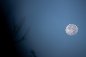 Full moon over blue sky