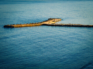 Fototapeta premium Concrete pier in Black Sea, Varna, Bulgaria. Sunset time