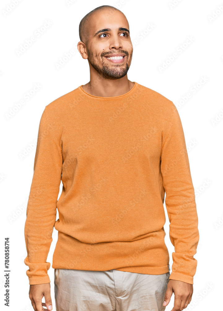 Sticker Hispanic adult man wearing casual winter sweater looking away to side with smile on face, natural expression. laughing confident.