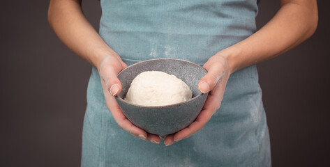 Fresh wheat dough, baker holds bowl with flour, bread or pizza, prepare ingredients for food,...