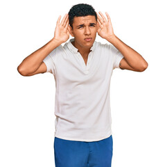 Young arab man wearing casual clothes trying to hear both hands on ear gesture, curious for gossip. hearing problem, deaf