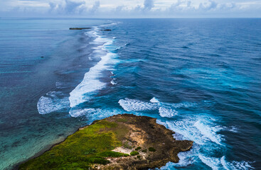 Natural background. A storm on an island in the ocean with a lighthouse.