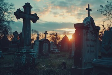 A cemetery at sunset with a prominent cross in the foreground. Suitable for religious themes - obrazy, fototapety, plakaty
