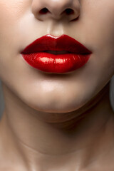 Fototapeta premium A close-up of lips with a slight smile and red lipstick