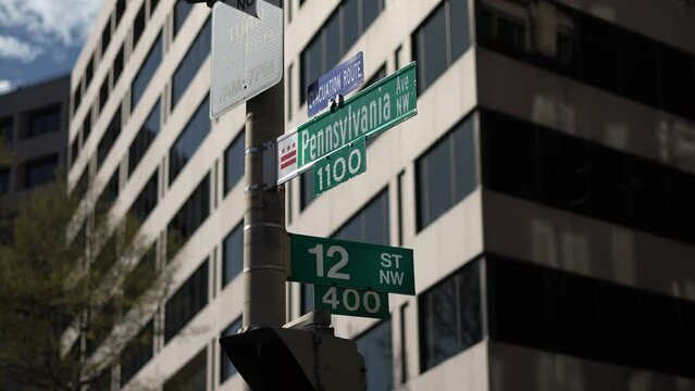 Pennsylvania Avenue, NW and 12th street NW street signs in downtown Washington DC area of lobbying and lawyers in nations capital