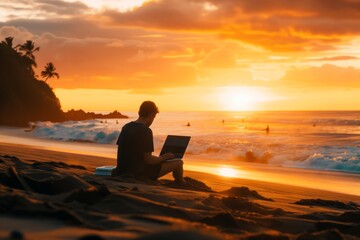 freelancer on the beach at sunset working on a laptop