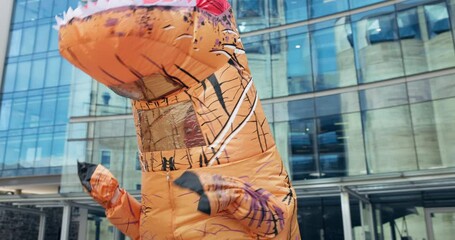 Mascot, dance and city with money rain, urban office building and documents for work. Costume, inflatable dinosaur and fun for entertainment, company culture and prank with funny business joke