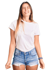 Fototapeta premium Beautiful caucasian woman wearing casual white tshirt sticking tongue out happy with funny expression. emotion concept.
