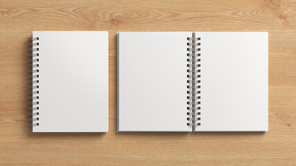 Notebook mockup. Closed and open blank notebook with white cover. Spiral notepad on wooden background