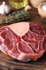Piece of raw beef meat on wooden board, closeup