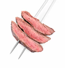 Schilderijen op glas Meat fork with grilled beef pieces isolated on white, top view © New Africa