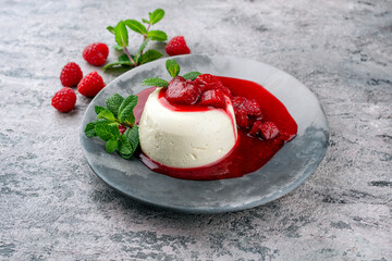 Traditional quark mousse with rhubarb and raspberry compote served as close-up on a Nordic Design...