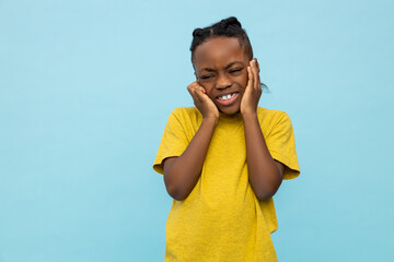 Frustrated African American little boy covering ears