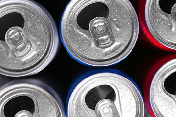 Energy drinks in wet cans as background, top view. Functional beverage