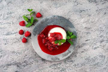 Traditional quark mousse with rhubarb and raspberry compote served as top view on a Nordic Design...