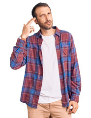 Young handsome man wearing casual clothes shooting and killing oneself pointing hand and fingers to head like gun, suicide gesture.